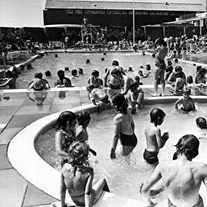 Holiday makers enjoy the Swimming and Paddling Pools at Trecco Bay, Porthcawl, Bridgend