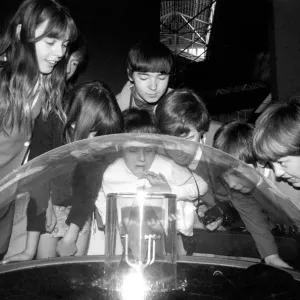 Holiday makers looking at the moon rock from Apollo IIs moon landing Holiday makers looking at the moon rock from Apollo IIs moon landing