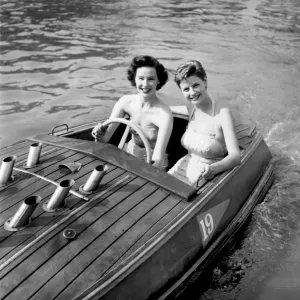 Holiday Two young women enjoying the boating pool at the Festival pleasure gardens