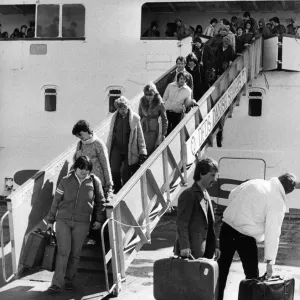 These holidaymakers look unhappy that their holiday is over