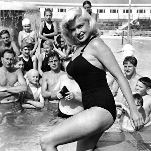 Holidaymakers take pictures of Hollywood superstar Jayne Mansfield at a swimming pool in