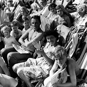 Holidays: Holiday makers Sunbathing whilst watching the Minor Beach Fashion Show