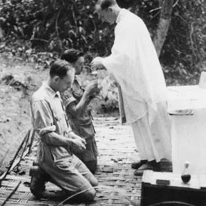 Holy communion in Burma. Padre squadron leader C. B. Westcott of Northhampton administers Holy communion in Burma. Padre squadron leader C. B. Westcott of Northhampton administers