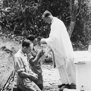 Holy communion in Burma. Padre squadron leader C. B. Westcott of Northhampton administers