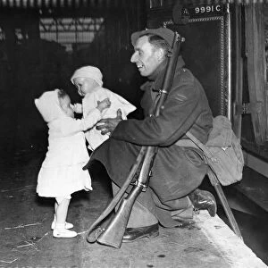Home on Leave for Christmas. 1942. A soldier gives his daughter a doll