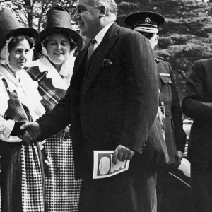 Home Secretary David Maxwell Fyffe greets a woman in national dress at the Welsh
