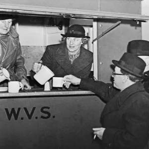 Home Secretary Herbert Morrison served tea by a W.V.S. volunteer in print form Home Secretary Herbert Morrison served tea by a W.V.S. volunteer in print form