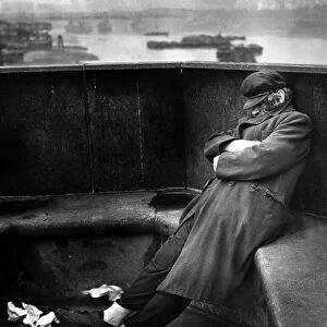 Homeless tramp sleeping rough on Blackfriars Bridge, May 1943