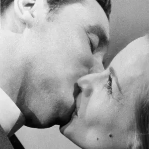 Honor Blackman Kissing Patrick Macnee Print - January 1964