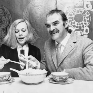 Honor Blackman and Stanley Baker eating with chopsticks Print