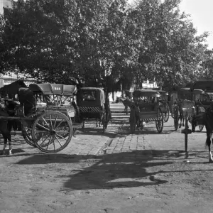 Horse - drawn taxis seen here waiting outside Poonah railway station. April 1959