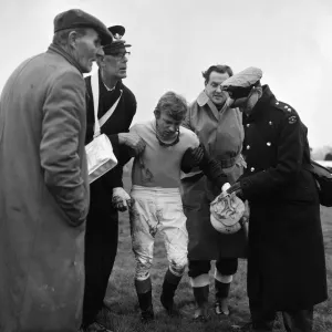 Horse racing at Windsor, a jockey who has fallen from his horse is helped Horse racing at Windsor, a jockey who has fallen from his horse is helped