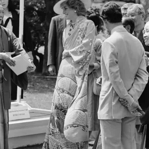 HRH Princess Diana, The Princess of Wales, is helped by city officials to wear a