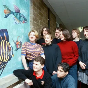 Huddersfield New College pupils are pictured by the mural they spent six months painting