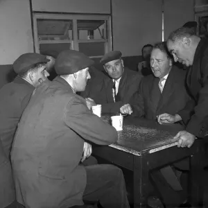 Hugh Gaitskell, MP, 1958 talks with Liverpool dockers over a mug of tea in Gladstone Dock