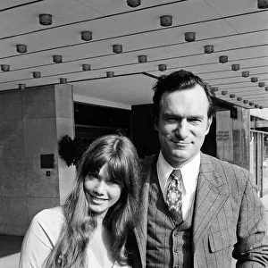 Hugh Hefner outside the Hilton Hotel with his girlfriend Barbara Benton