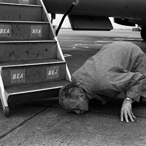 Hughie Green April 1963 Comedian TV Presenter kissing the ground at London Airport