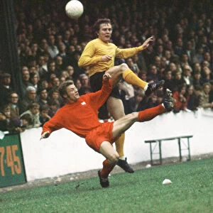 Hull City footballer Ken Wagstaff in action, challenged for the ball by Dennis Rofe of