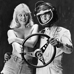 Ian Ashley and Angela Jay pose together holding a steering wheel