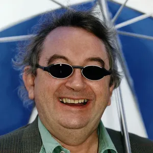 Ian McCaskill wearing a pair of BHS Ultraviolet Protection Sunglasses holding umbrella Ian McCaskill wearing a pair of BHS Ultraviolet Protection Sunglasses holding umbrella