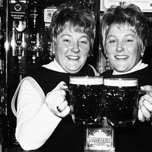 Identical twin barmaids Joan Metcalf and Marie Dunn seen here behind the bar 1977