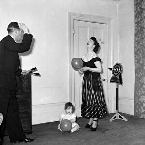 Illusionist Jon Evans practises his knife throwing with his partner and child