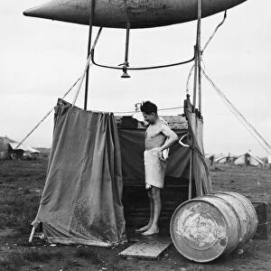 Improvised shower made from an empty fuel tank in Eastern Italy, used by Aircraftman C