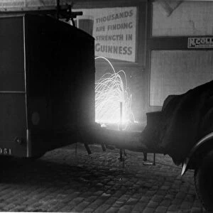 Incendiary bomb detonates close to a fire engine in the City of London. October 1940