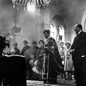 Incense burns as Father Spiros Desylas intones during a service at the Greek Orthodox