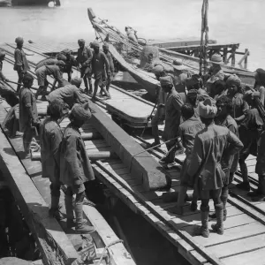 Indian troops under the direction of British officers unload a barge on the Tigris River Indian troops under the direction of British officers unload a barge on the Tigris River