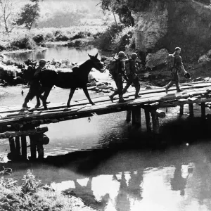 US infantry of Mars Task Force cross temporary bridge in Burma during WW2