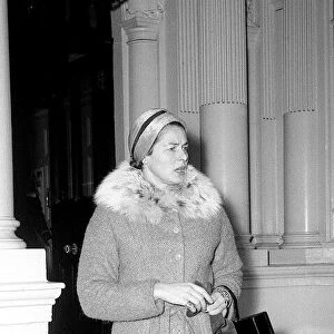 Ingrid Bergman window shopping in Bond Street London wearing fur trimmed tweed suit