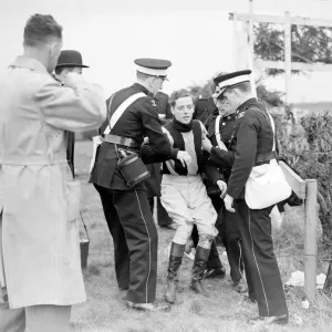 Injured jockey R Curran (Ulster Monarch) is helped to his feet in The Grand National Injured jockey R Curran (Ulster Monarch) is helped to his feet in The Grand National