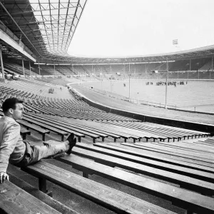Injured Liverpool footballer Gordon Milne looks out over Wembley Stadium as his teammates Injured Liverpool footballer Gordon Milne looks out over Wembley Stadium as his teammates