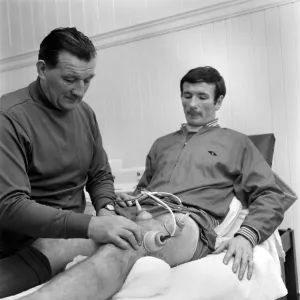 Injured Liverpool player Tommy Smith receives treatment from Bob Paisley in the treatment Injured Liverpool player Tommy Smith receives treatment from Bob Paisley in the treatment