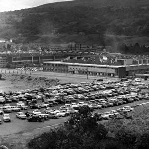 Instead of the long dole queues, a shiny row of cars. This scene at the Hoover factory