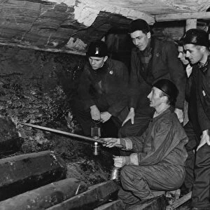 An instructor at the Government pit school showing Bevin Boys how to follow a seam of