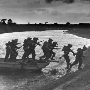 Invasion training in Southern England. Infantry are seen leaving a small assault boat Invasion training in Southern England. Infantry are seen leaving a small assault boat