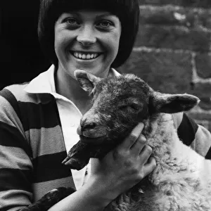 Isla St Clair actress with a lamb on location for the new series of The Farm