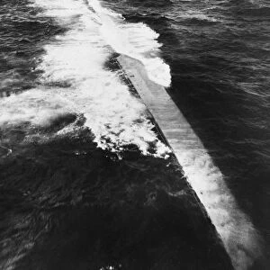 The Italian destroyer Tigre lies on its side after being scuttled due to heavy bombing by