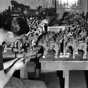 J. McCarthay of the RAF puts the finishing touches to a toy boat J. McCarthay of the RAF puts the finishing touches to a toy boat