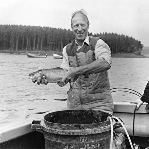 Jack Charlton releases one of the tagged trout at Kielder Reservoir with his mam Cissie