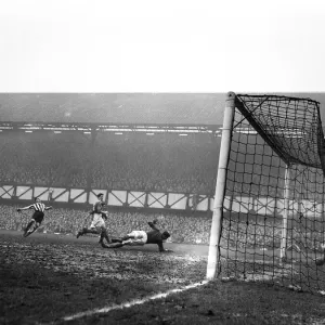 Jackie Milburn of Newcastle United scores a goal against Portsmouth. FA Cup Quarter-final