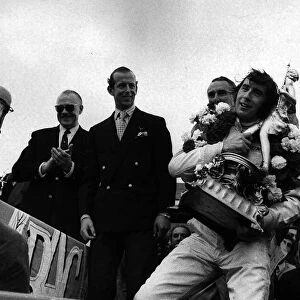 Jackie Stewart after winning British Grand Prix holding trophy July 1969