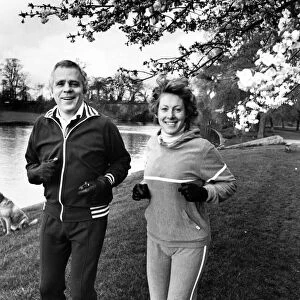 Jaguar boss Mr John Egan sets out on a morning run with his wife Julia. 23rd April 1983