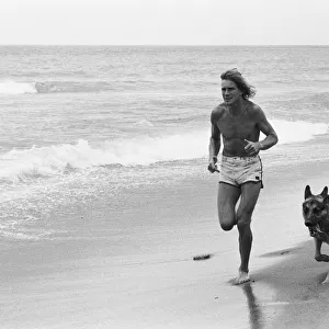 James Hunt jogging on beach with his dog Oscar in Marbella 9th May 1979