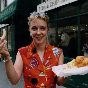 Janice Forsyth TV presenter in Rothesay fish chips supper orange shirt