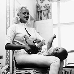 Jayne Mansfield changes the nappy of her son Mickey July 1959