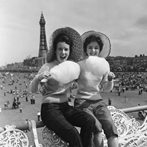 Jean Clark and Mary Cuppler enjoy eating candy floss on the pier at Blackpool, Lancashire