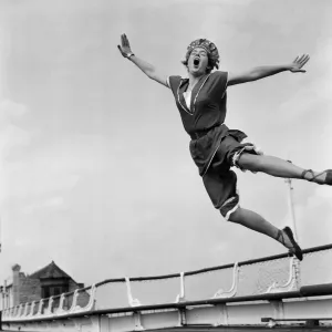 Jean Richardson, aged 23 from Bath, wears a 1890 bathing costume as she leaps high in Jean Richardson, aged 23 from Bath, wears a 1890 bathing costume as she leaps high in